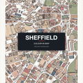 A finished, coloured-in Sheffield city map print — real streets and building outlines of Sheffield centre, filled by hand